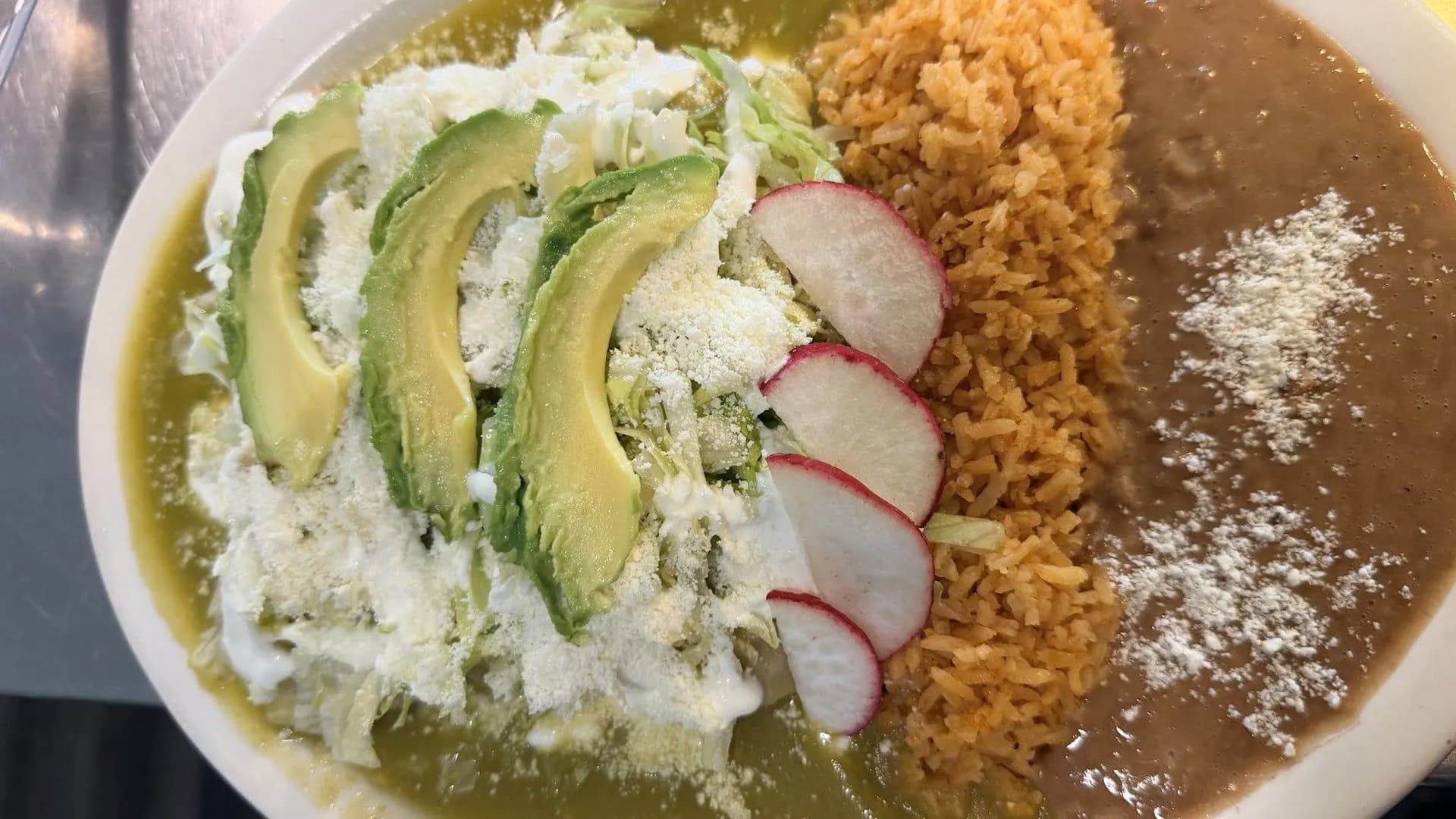 Enchiladas verdes with rice and refried beans at El Pilón in Wilmington